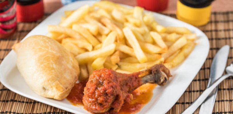 Regional African Food on white plate on wooden background