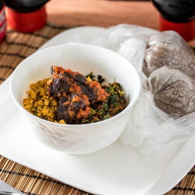 Regional African Food on white plate on wooden background