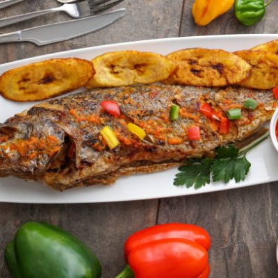 African national food dish. Nigerian Grilled meat and chicken dish. Nigerian Fish curry. Home-made plantain with Jollof Rice. Nigerian Meal Jelly Food. Rice and curry. Grilled African fish dish meal and Plantain & banana meal dish.
