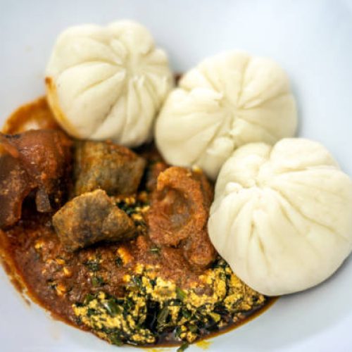 Lagos, Nigeria on January 21, 2025. Pounded yam, Vegetable soup and stew with liver and pommo served in a white dish in a Lagos restaurant.